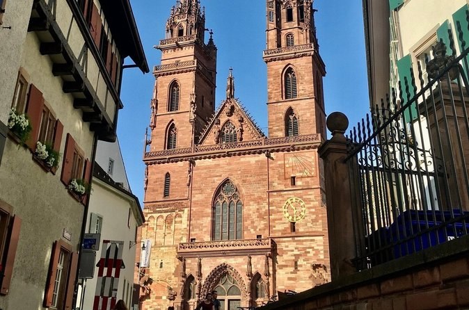 The Minster's red sandstone front seen up a narrow lane