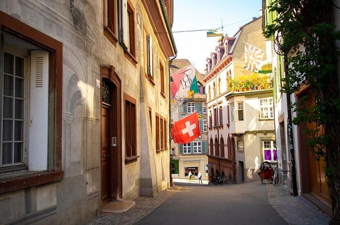 A quiet Old Town lane, a Swiss flag hanging above it