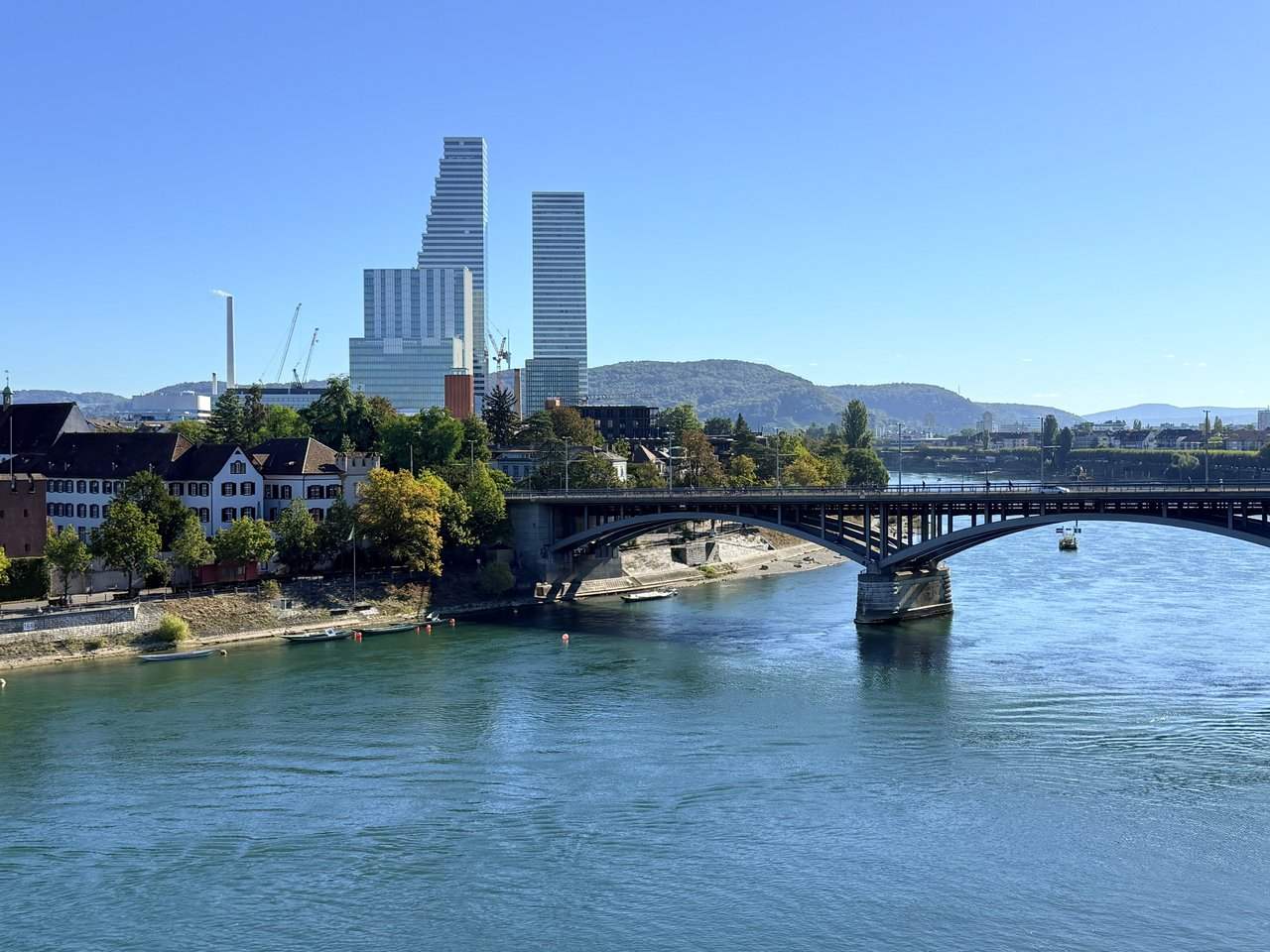 The Rhine under a steel-arched bridge, two tall towers on the skyline
